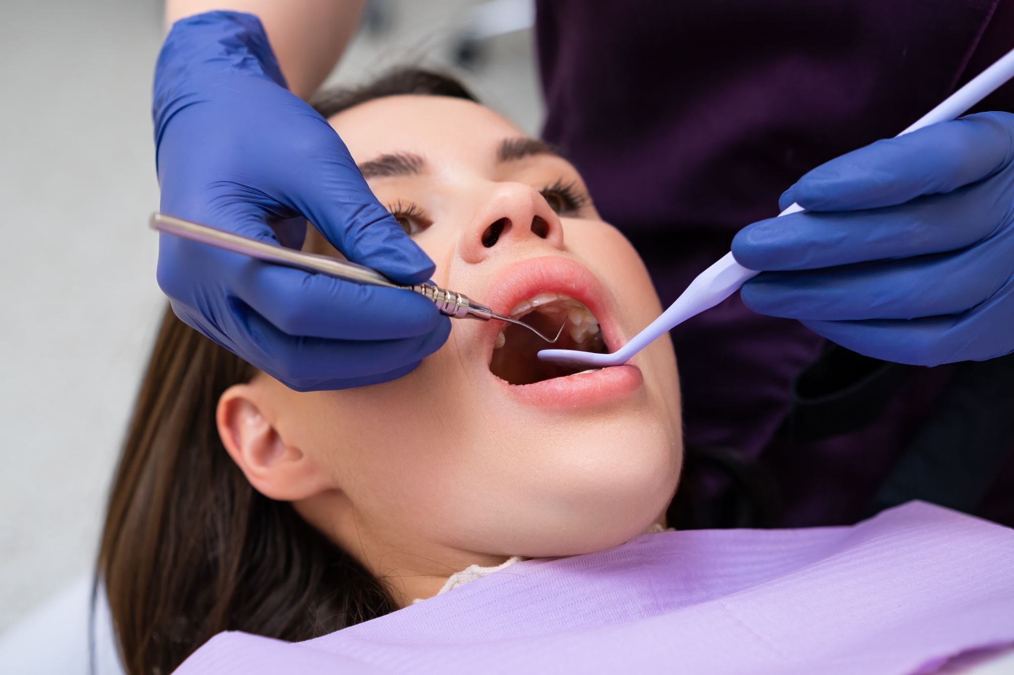 Woman receiving a dental checkup before a dental filling procedure