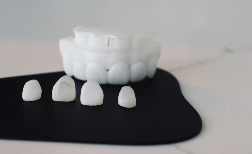 Dental model and tooth caps display to restore damaged teeth